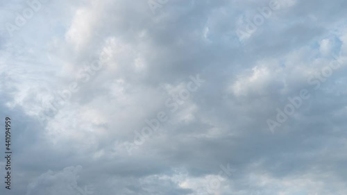 Dramatic clouds on a bright blue sky.Majestic summer landscape. Slow motion timelaps 4K footage. Looking up in the heaven. Clouds at sunset sky. Romantic colors