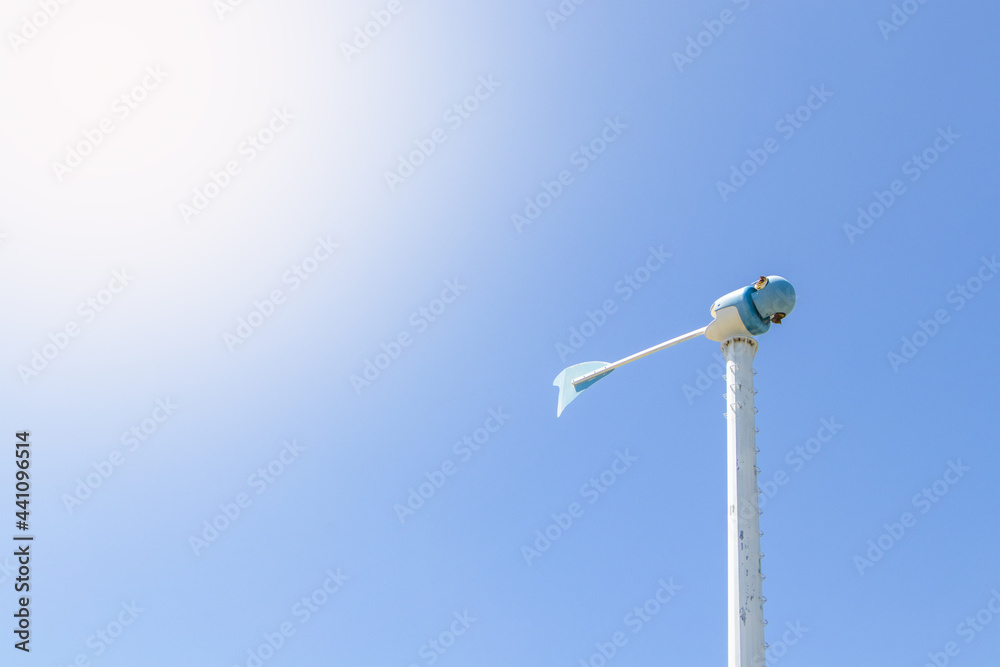 Photo from below windmill or also wind-turbine damaged by a storm in rotation to generate electricity energy on outdoor with sun and cloudy sky a background , conservation and sustainable energy conce