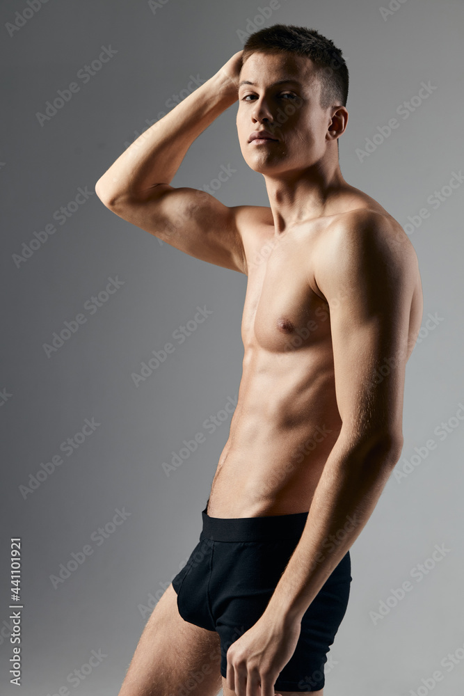 bodybuilder fitness man with a pumped-up torso hand behind head gray background model 