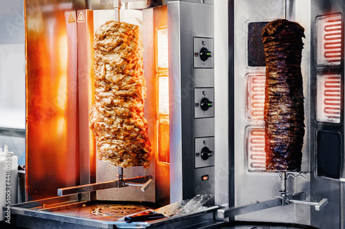Fresh Turkish shawarma kebab, meat cooked on an electric skewer. photo