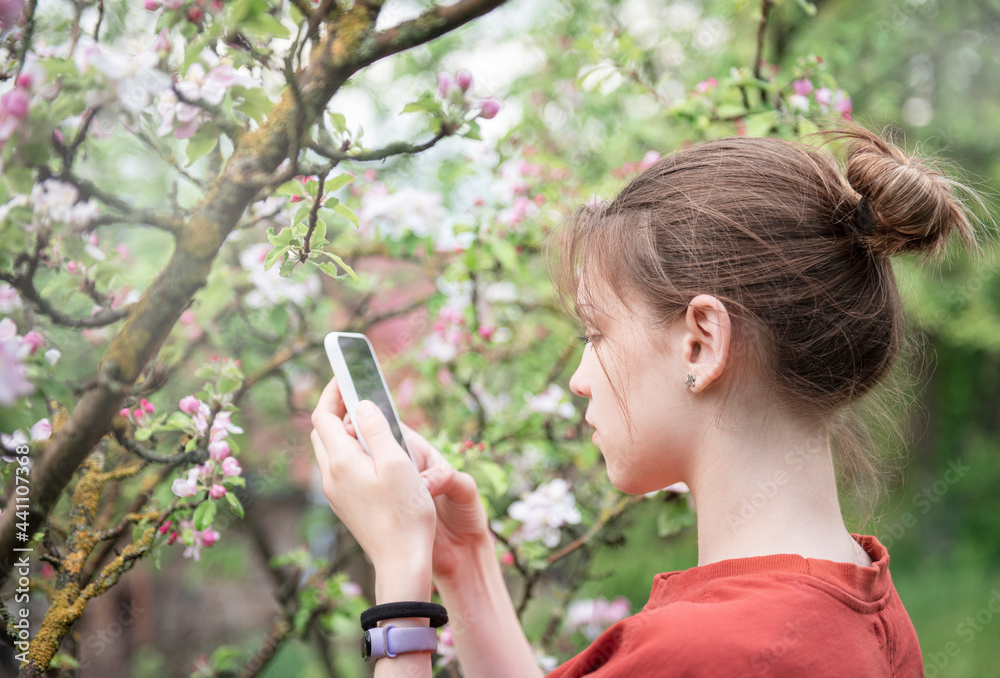 Young teenage girl in a blooming garden Young teenage girl in a blooming garden