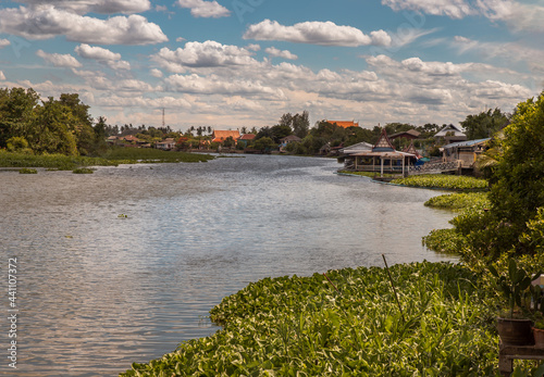 Beautiful view of Tha chin river (Maenam Tha Chin) in the midst of bright skies and shady nature at Nakhonpathom. Copy space, Selective focus.