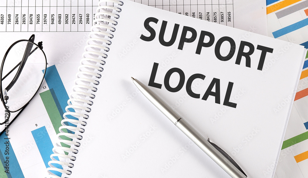 SUPPORT LOCAL , pen and glasses on the chart, business concept SUPPORT LOCAL , pen and glasses on the chart, business concept