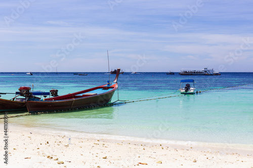 boats on the beach at white sand island and blue sky on sunny day