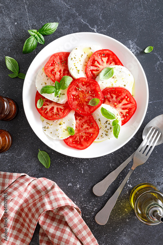 Caprese Salad with fresh tomatoes, basil and mozzarella cheese, top view