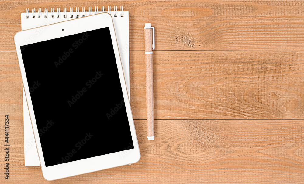 digital tablet, notepad and pen on wooden table digital tablet, notepad and pen on wooden table