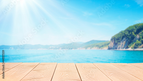 wooden table on defocus sea and mountains background