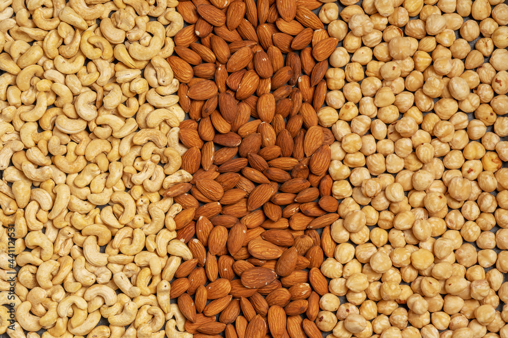 Close-up of nuts background: cashews, hazelnuts, almonds. Healthly food. A source of vitamins, microelements. Close-up of nuts background: cashews, hazelnuts, almonds. Healthly food. A source of vitamins, microelements.