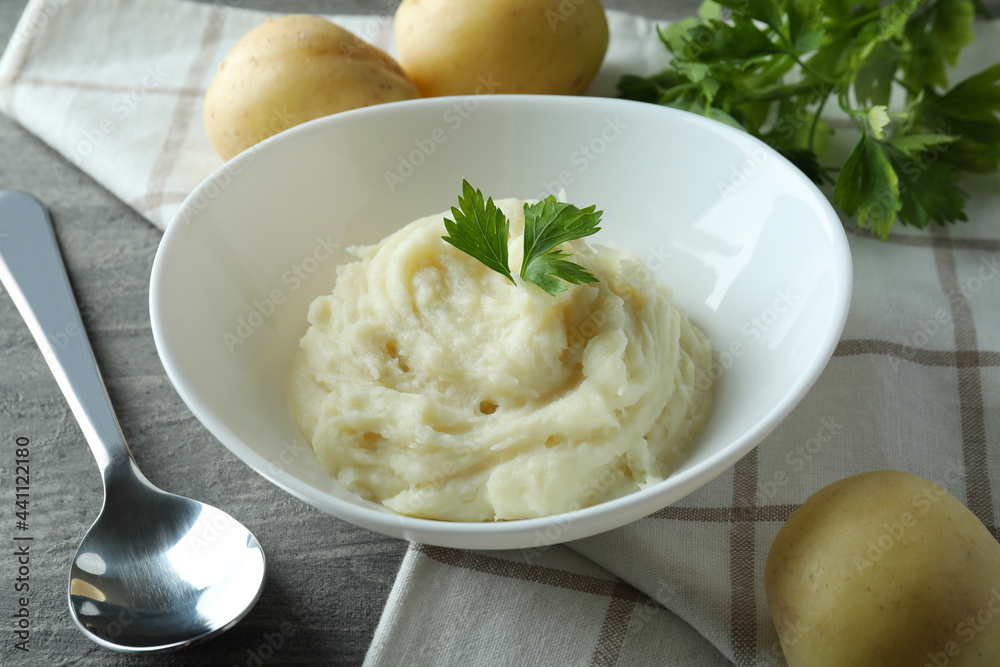 Concept of tasty eating with mashed potatoes on gray textured table