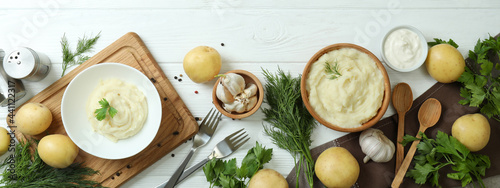 Fotografie Concept of tasty eating with mashed potatoes on white wooden table