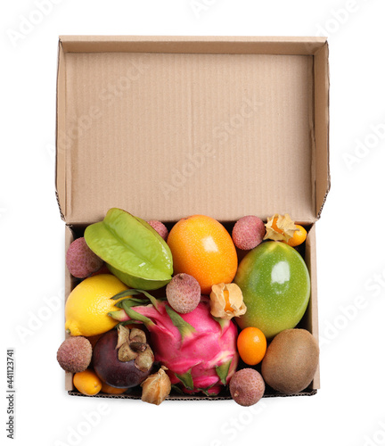Fototapeta Naklejka Na Ścianę i Meble -  Cardboard box with different exotic fruits on white background, top view