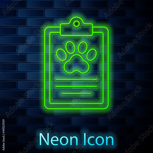 Glowing neon line Clipboard with medical clinical record pet icon isolated on brick wall background. Health insurance form. Medical check marks report. Vector