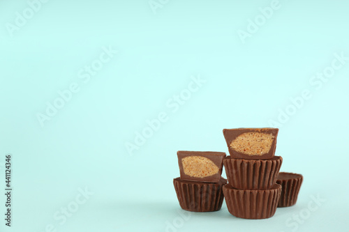Sweet peanut butter cups on turquoise background. Space for text