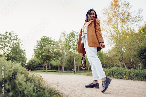 Young african american woman having a walk in a park