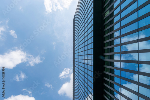 Business building. Modern office business building with glass, steel facade exterior. Finance corporate architecture city in abstract blue sky with nature cloud in sunny day.