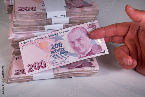 Hands holding 200 Lira banknote Turkish money (Turk Parasi). photo