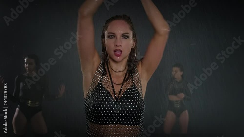 passionate dance of young lady under rain at night, go-go dance performance