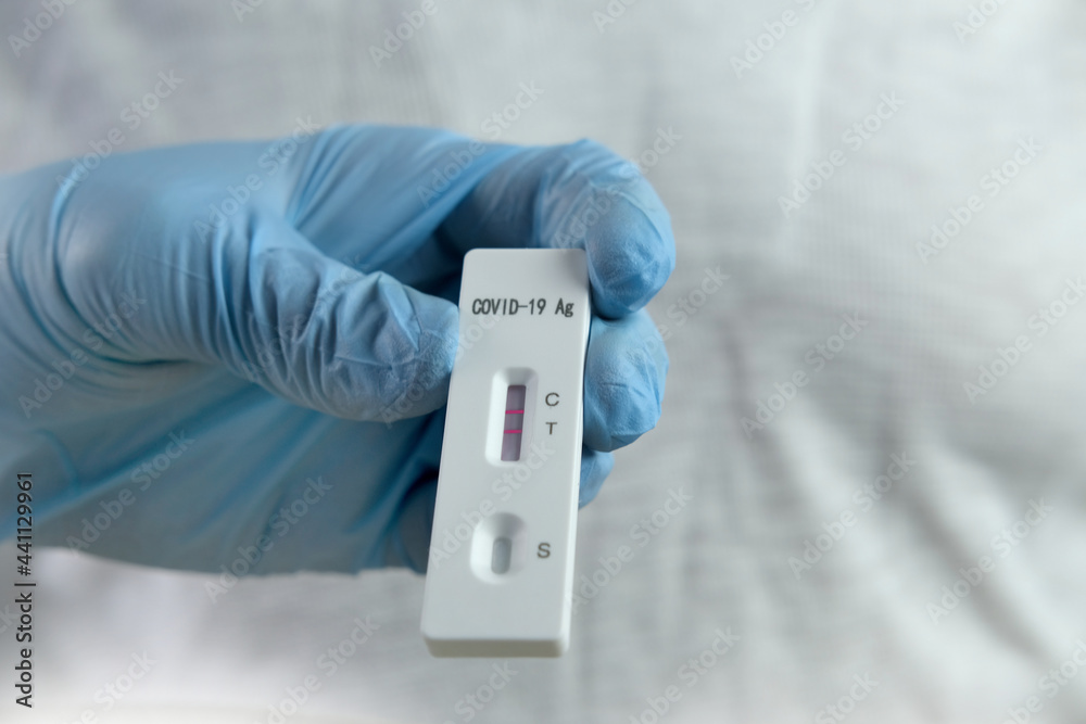 close-up of a male medic's hand holding a test cassette, medical disposable sterile test kit for rapid test covid-19, concept of early detection of viral disease, SARS-CoV-2 epidemic, coronavirus close-up of a male medic's hand holding a test cassette, medical disposable sterile test kit for rapid test covid-19, concept of early detection of viral disease, SARS-CoV-2 epidemic, coronavirus
