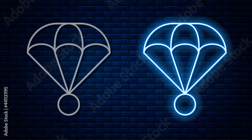 Glowing neon line Parachute icon isolated on brick wall background. Extreme sport. Sport equipment. Vector