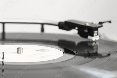 A spinning vinyl record on a turntable. Photo was taken in motion. Selective focus.