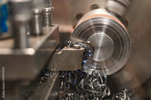 End trimming with a cutter on a lathe. Metal shavings on the machine. photo