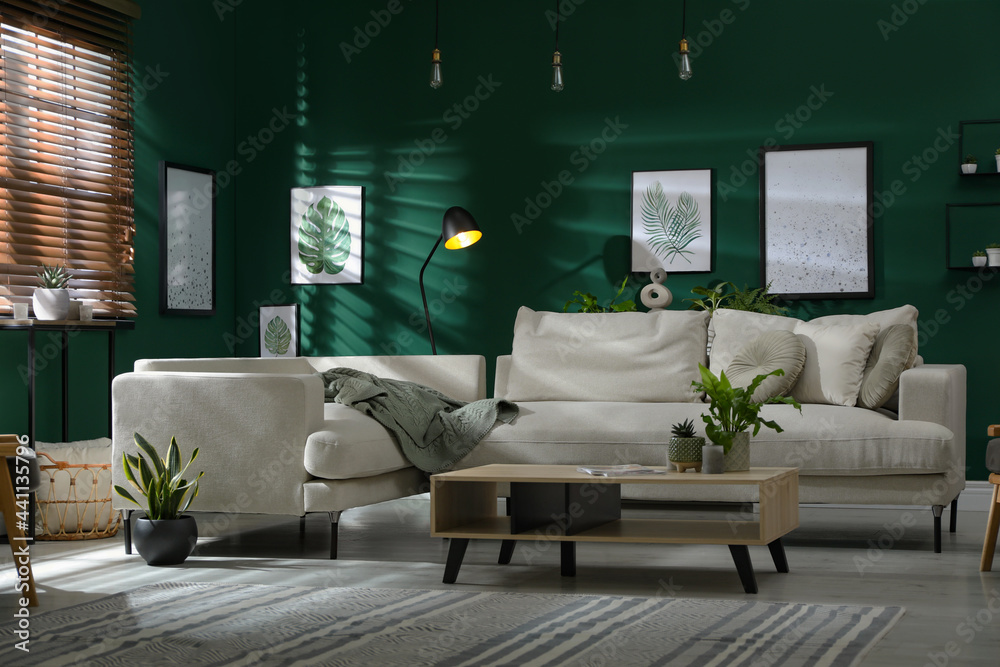 Modern living room interior with stylish comfortable sofa - obrazy, fototapety, plakaty 