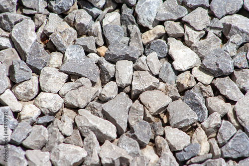 Gray gravel stones for the construction industry. Gravel texture