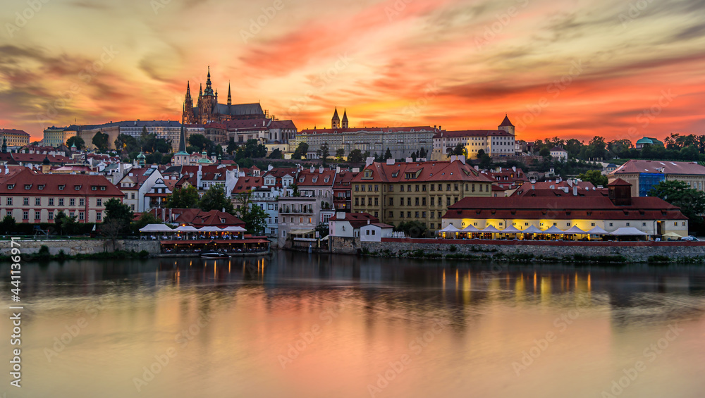 The famous Prague castle during a beautiful orange dusk.