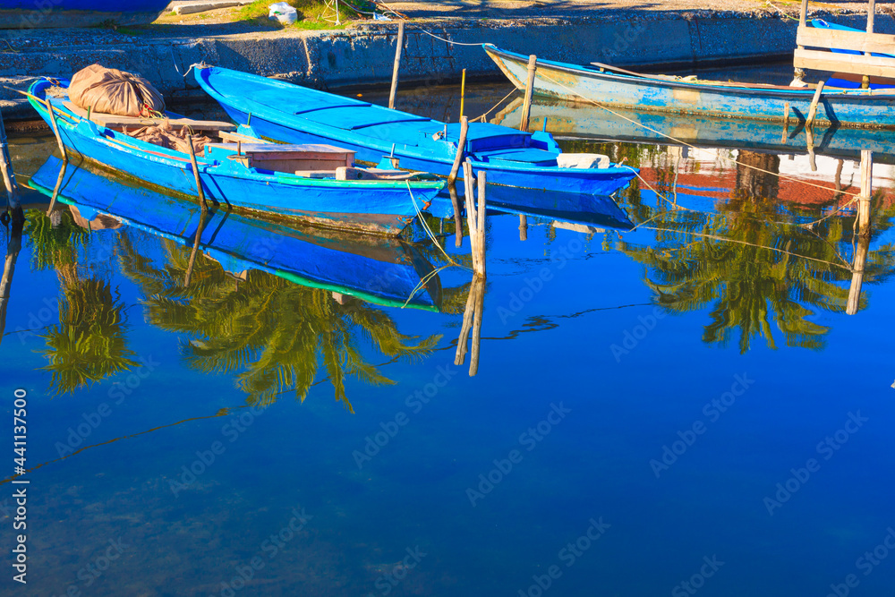 Greece, Beautifull reflections of wooden fishing boats on water on sea lake in Aitoliko in Central Greece
