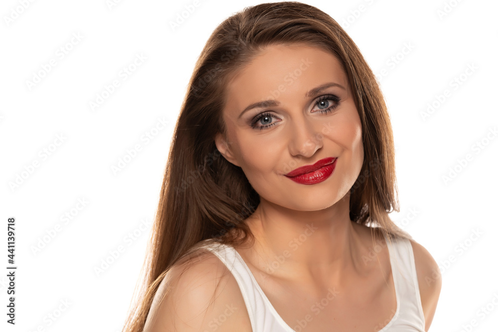 Portrait of a young beautiful and smiling woman with blue eyes and makeup