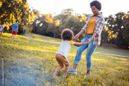 Mother and daughter holding hands and playing together.