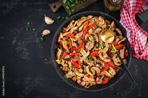 Stir fry with chicken, mushrooms and sweet peppers - Chinese food. Top view, above