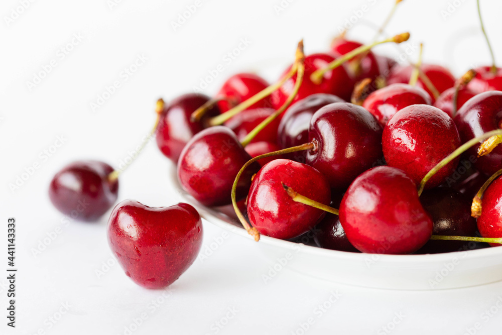 cherries in a bowl, white background cherries in a bowl, white background
