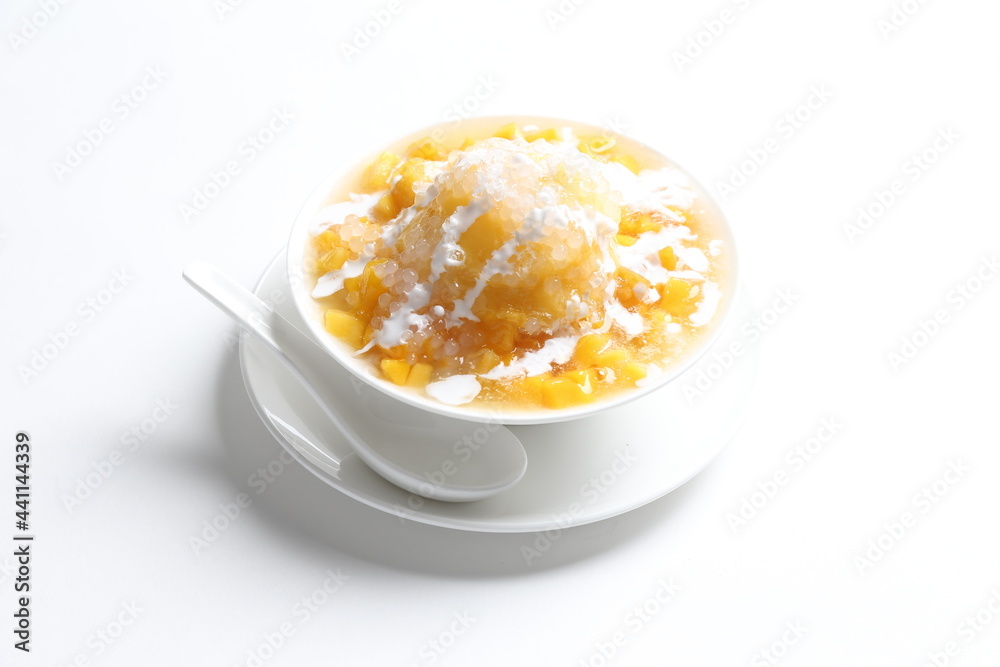 chilled fresh mango fruit sago ice snow kacang sweet dessert with coconut milk cream in white bowl chilled fresh mango fruit sago ice snow kacang sweet dessert with coconut milk cream in white bowl