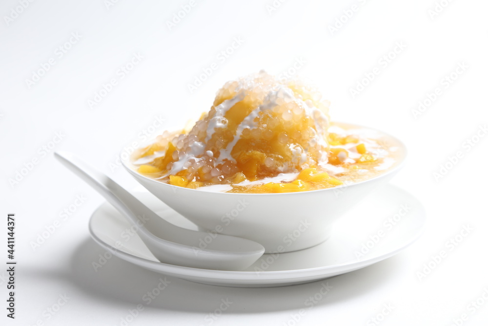 chilled fresh mango fruit sago ice snow kacang sweet dessert with coconut milk cream in white bowl chilled fresh mango fruit sago ice snow kacang sweet dessert with coconut milk cream in white bowl