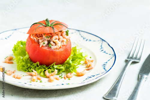typical Belgian meal stuffed tomato with north sea shrimp on white and blue plate