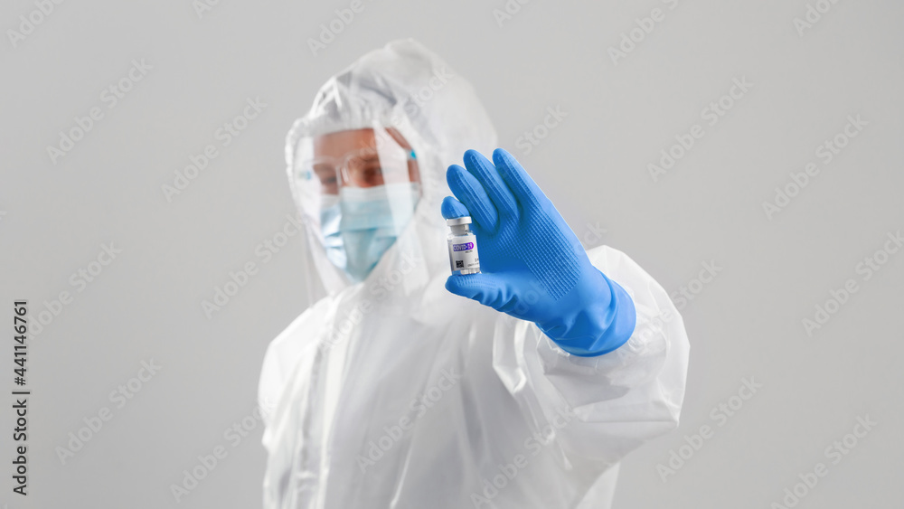 Young Caucasian men in hazmat suit wearing surgical face mask and face shield during Coronavirus pandemic prevention. Young physician doctor in protective ppe suit Young Caucasian men in hazmat suit wearing surgical face mask and face shield during Coronavirus pandemic prevention. Young physician doctor in protective ppe suit