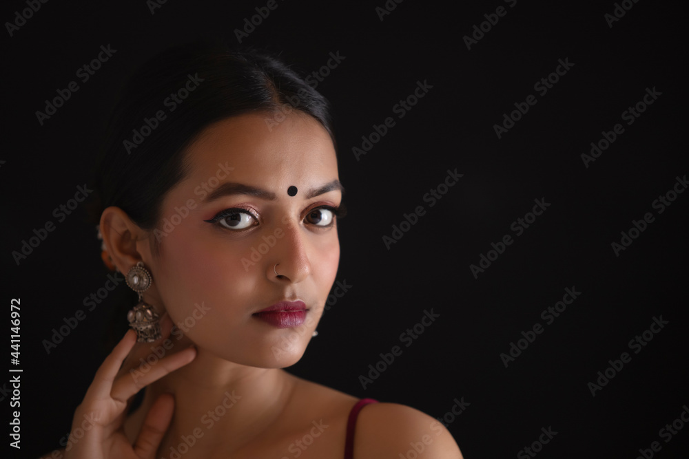 Fototapeta premium Portrait of a beautiful woman Against Black background