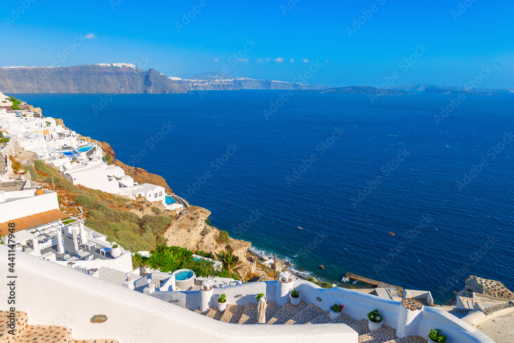 Greece famous Santorini island in Cyclades, panoramic view of traditional whitewashed and colorful houses with caldera sea in background