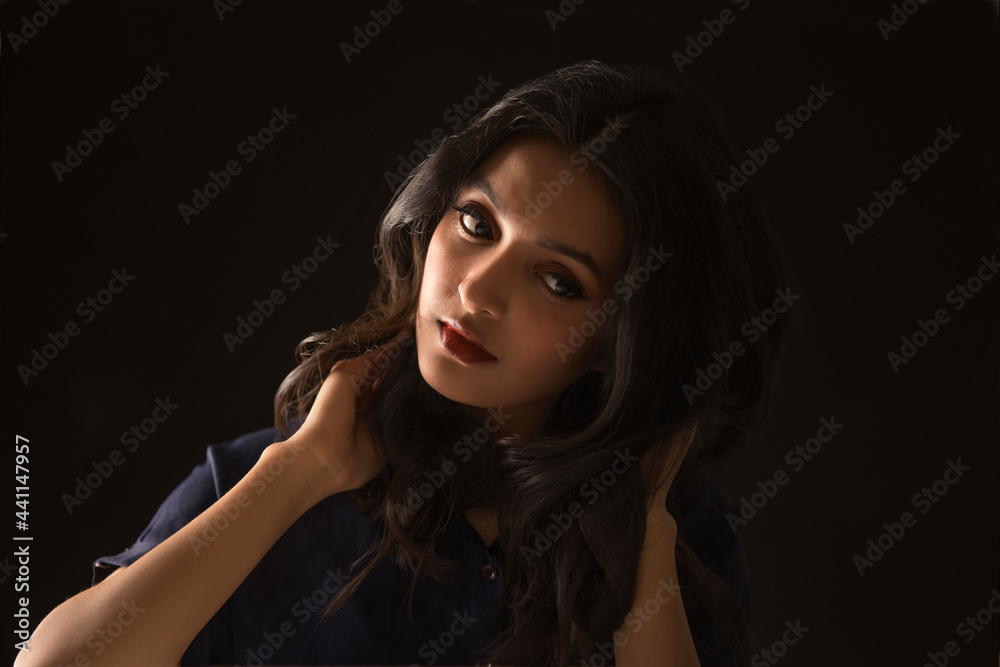 Portrait of a beautiful woman on a dark background Portrait of a beautiful woman on a dark background