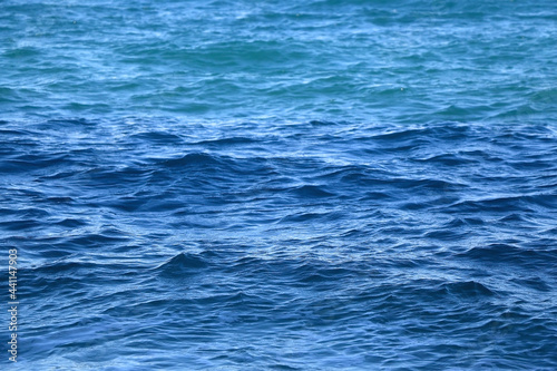Small waves on sea surface. Beautiful blue color. Selective focus.