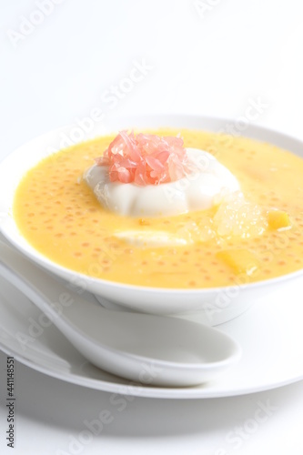 chilled mango sago fruit with pomelo and soya pudding jelly in white bowl sweet dessert menu photo
