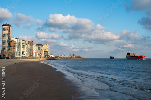Waterfront, dunes and view on Vlissingen city with sandy beach on sunset