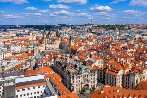 Prague beautiful panoramic sunny aerial drone view above Prague Old Town Square with Church of Our Lady before Tyn and Prague Astronomical Clock Tower. Drone flight over red roofs of Prague, Czechia. photo