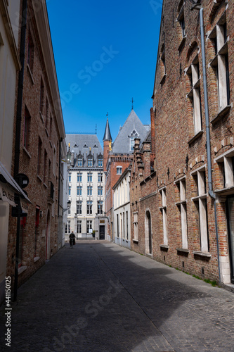 Fototapeta Naklejka Na Ścianę i Meble -  27 April 2021, Bruges, Belgium, walking on medieval Bruges streets in sunny day, travel destination