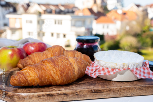 French breakfast with fresh baked croissants and cheeses from Normandy, camembert and neufchatel served outdoor with nice city view