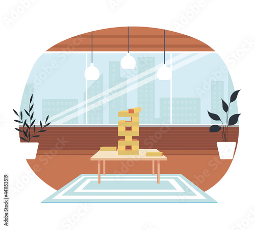 Cozy living room atmosphere with board game. Tower of wooden bricks on table. Jenga board game for playing together at home. Wooden blocks stacked in high tower. Living room interior for playing games