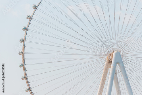 Close-up details of the Ferris wheel with metal beam guides and passenger booths. Dubai Eye on Bluewaters island