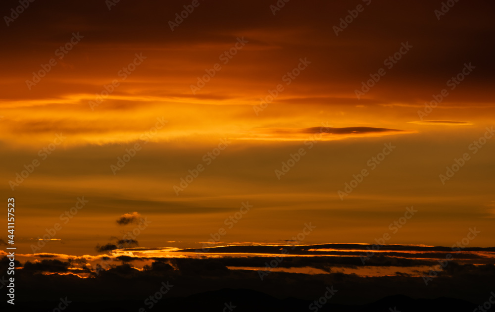 Sunset sky with orange clouds. Nature background.