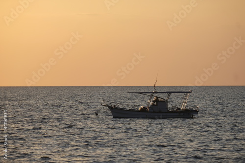 Beautiful sunset with fishing boat © Pitchy